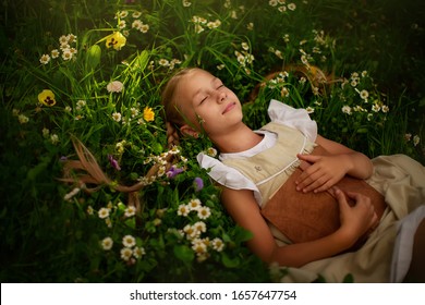 A pretty girl with pigtails in a white dress is lying in a clearing with flowers, reading a book. Reading.