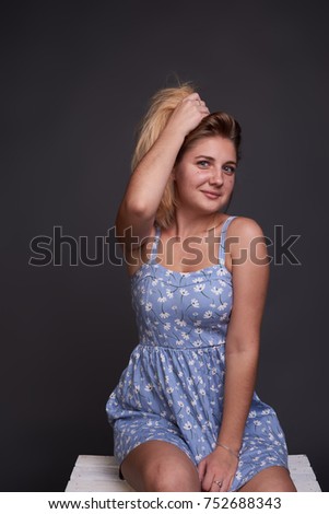 Pretty girl posing in beautiful blue in white dot dress