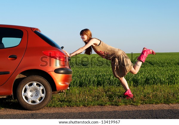 Pretty girl pushing a\
car