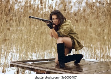 pretty girl shooting from hunting rifle