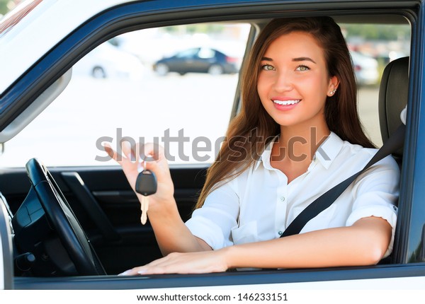 Pretty girl showing the car key\

