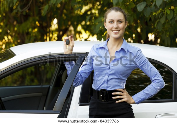 Pretty girl showing the car\
key