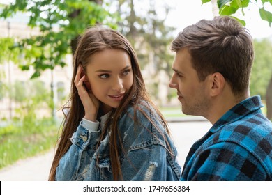 pretty girl touching hair while flirting with boyfriend