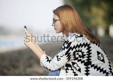 Pretty Girl Using Mobile Phone Outdoor