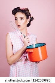 pretty girl in vintage style. pin up woman with trendy makeup. pinup girl with fashion hair. perfect housewife. retro woman cooking in kitchen. Cooking with passion.