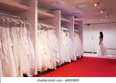 Pretty Girl In A Wedding Gown In The Bridal Shop.