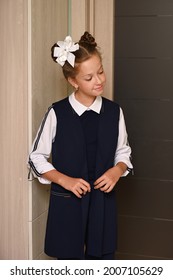 Pretty Girl With A White Bow In Her Hair And A Beautiful School Uniform Is Going To School On The First Day. Back To School. Knowledge Day