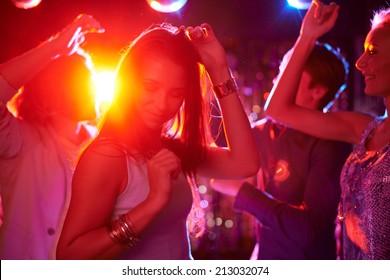 Pretty Girls Dancing In Night Club On Background Of Guys