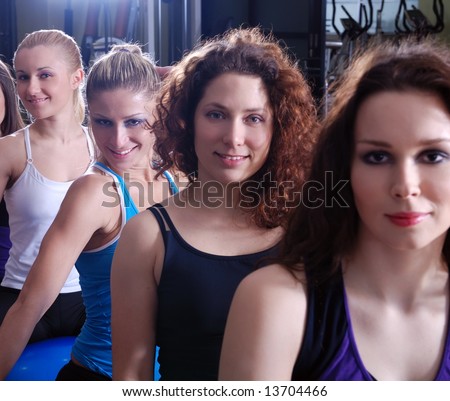 Similar – Close up front portrait of three young and middle age athletic women in sportswear in gym over dark background, looking at camera