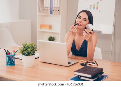 Pretty Happy Businesswoman Doing Make Up In Office