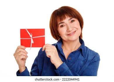 Pretty Happy Middle Aged Woman Holding Gift Voucher Over White Background