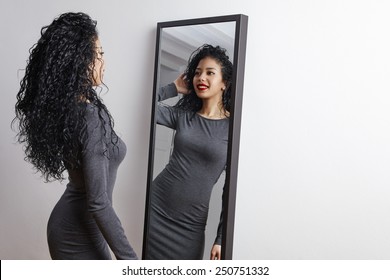 Pretty Happy Woman Watching On Herself In A Big Mirror