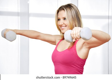 Pretty Happy Young Woman Exercising With Free Weights