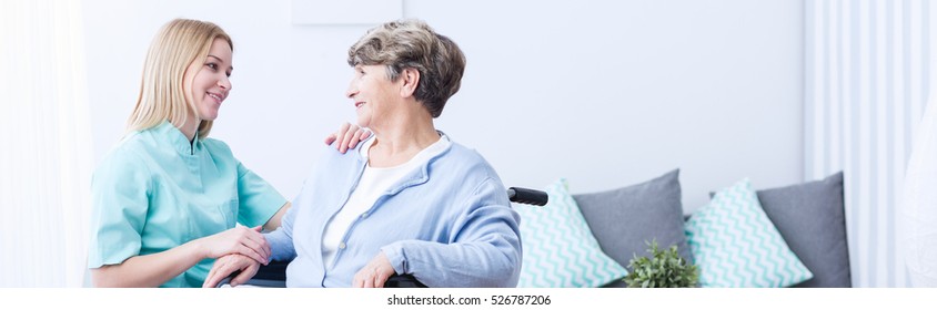 Pretty helpful carer talking with female patient