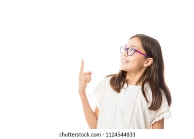 Pretty Hispanic 10 Year Old Girl Pointing With Finger To The White Background