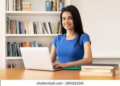 Pretty Hispanic Female Student Learning Online At Computer Indoor At Desk At Home