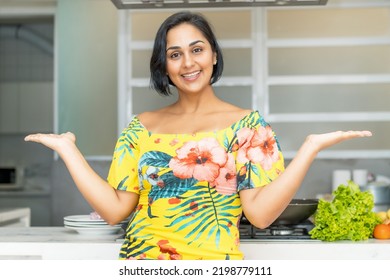 Pretty Hispanic Mother Or Housewife At Kitchen Indoors At Home