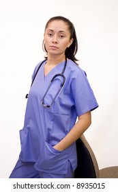 Pretty Hispanic Nurse Isolated On White On Phone With File Folder