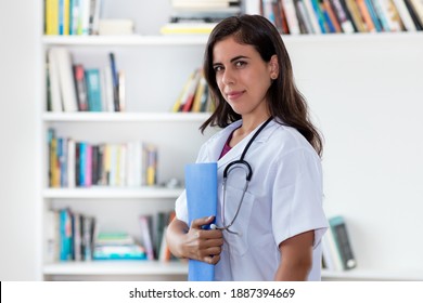 Pretty Hispanic Nurse Or Medical Student At Work At Hospital