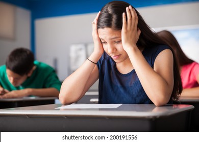 Pretty Hispanic Teen Stressed Out During A Test For High School