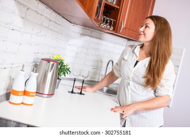 Pretty Housewife Admiring With Her New Domestic Kitchen