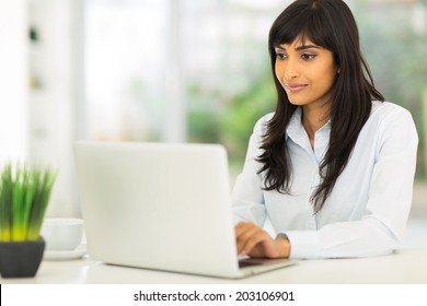 Pretty Indian Businesswoman Using Computer In Office