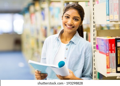 Pretty Indian College Girl Reading A Book In Library
