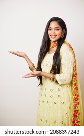 Pretty Indian girl greeting against white. - Shutterstock ID 2088397243