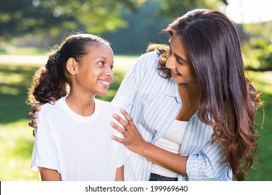 Pretty Indian Mother Talking To Her Beautiful Daughter Outdoors