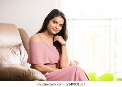 Pretty Indian young woman on sofa at home - Shutterstock ID 2149881587