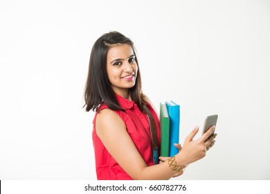 Pretty Indian/Asian College Girl Holding Books And Clicking Selfie With Smartphone, Standing Isolated Over White Background