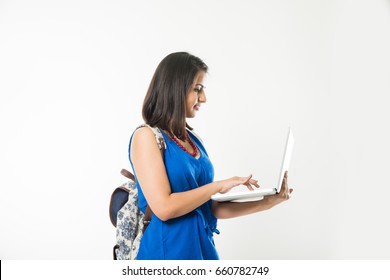 Pretty Indian/Asian College Girl Using Or Holding Laptop Computer With Bag, Standing Isolated Over White Background