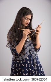 Pretty Indian/asian Young Girl Artist With Paint Brush And Colour Palate, Standing Isolated Over White Background