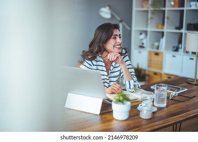 Pretty pretty lady with black hair working at laptop sitting at a table at home - check out online stores selling cyber mondays - tech woman concept for alternative freelance office