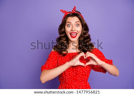 Pretty lady holding arms in heart figure expressing safety cardiology wear red dress isolated purple background