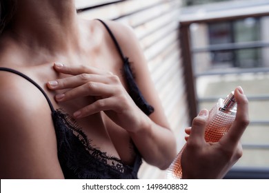 Pretty Lady Putting On Her Parfume At Home