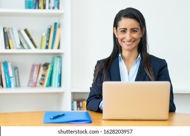 Pretty Latin American Mature Businesswoman With Blazer At Computer At Office