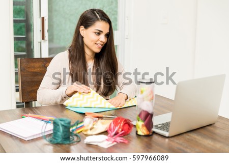Similar – Image, Stock Photo Young woman crafting with paper at a creative workspace