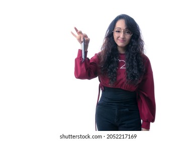 Pretty Latino Hispanic Woman With Long Thick Hair Wearing Glasses On White Background Indoors Making Expressions And Gestures, Confused, Surprised, Tense, Stressed, Perplexed,holding Her Phone With On