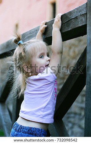 Similar – Happy little girl playing in a urban playground.