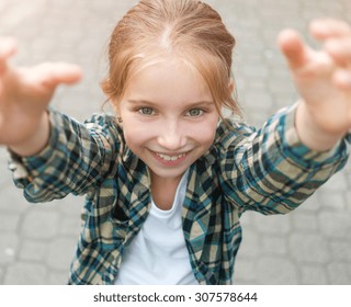 Pretty Little Girl With Arms Up To Reach Something