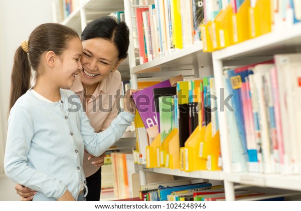 Pretty Little Girl Picking Books Bookshelf Royalty Free Stock Image