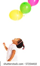 Pretty little girl playing with colorful balloons on white background