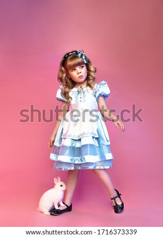 Pretty little girl with rabbit, Alice in wonderland, cute child 