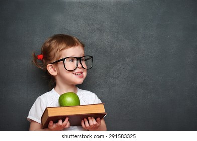 pretty little girl schoolgirl with books and apple in a school board - Powered by Shutterstock