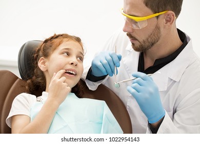 Pretty Little Girl Visiting Dentist At The Clinic Pointing At Aching Tooth In Her Mouth Copyspace Emergency Healthcare Medicine Help Helpful Experienced Children Kids Doctor Patient Dentistry