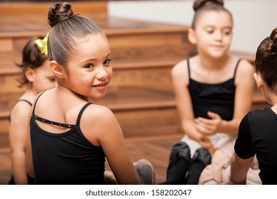 Pretty Little Hispanic Girl And Her Friends Taking A Break From Dance Class And Smiling