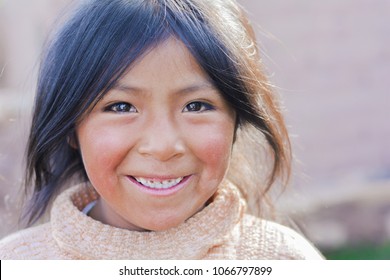 Pretty little latin girl smiling happily outside.