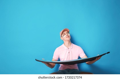 Pretty Man With Flowers Under His Eyes, Wearing Pink Clothes. Boy On Blue Background With Happy Emotions, Using Ring For Sun Shining