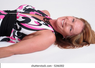 Pretty, Mature Woman Laying Down Looking At Camera